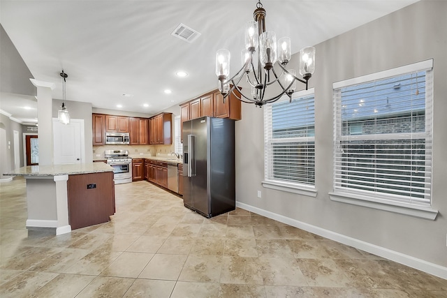 6222 Deer Run Xing, Katy, TX 77493 - kitchen featuring stainless steel appliances, brown cabinets, a chandelier, light stone counters, and pendant lighting
