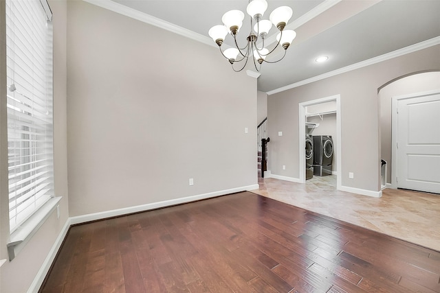 6222 Deer Run Xing, Katy, TX 77493 - unfurnished room featuring washing machine and clothes dryer, hardwood / wood-style floors, crown molding, a chandelier, and arched walkways