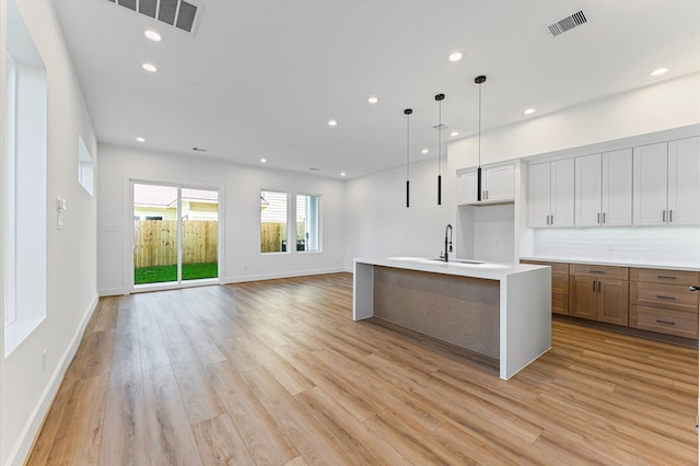 507 Middle St, Houston, TX 77003 - kitchen featuring light wood-type flooring, recessed lighting, open floor plan, and light countertops