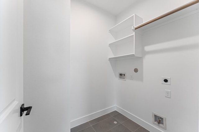 507 Middle St, Houston, TX 77003 - laundry room with electric dryer hookup, dark tile patterned flooring, washer hookup, and gas dryer hookup