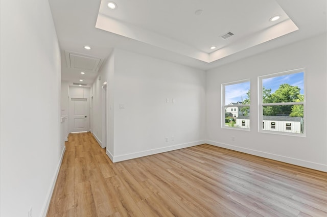 507 Middle St, Houston, TX 77003 - unfurnished room with a raised ceiling, recessed lighting, attic access, and light wood-style flooring