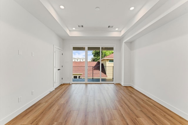 507 Middle St, Houston, TX 77003 - unfurnished room with a raised ceiling, light wood finished floors, and recessed lighting