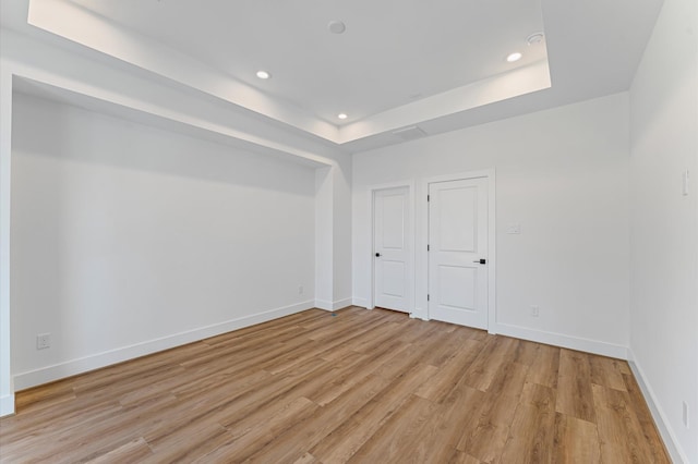 507 Middle St, Houston, TX 77003 - unfurnished room featuring light wood finished floors, a tray ceiling, and recessed lighting