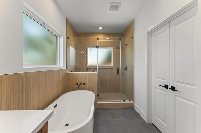 507 Middle St, Houston, TX 77003 - bathroom featuring tile patterned flooring, a stall shower, a freestanding bath, and vanity