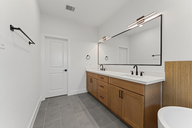 507 Middle St, Houston, TX 77003 - bathroom featuring double vanity, tile patterned flooring, and a freestanding bath