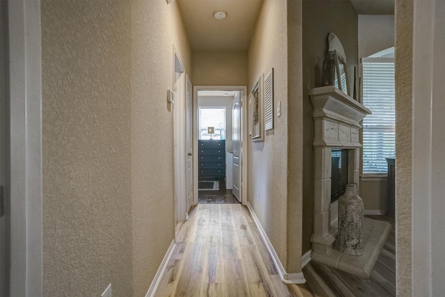 21714 Venture Park Dr, Richmond, TX 77406 - hallway featuring a textured wall and wood finished floors