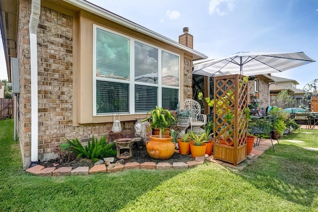 21714 Venture Park Dr, Richmond, TX 77406 - view of side of property with stone siding and a chimney