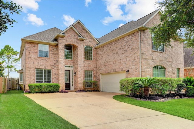 13508 Sweet Wind Ct, Pearland, TX 77584 - traditional-style house featuring a shingled roof, concrete driveway, and brick siding