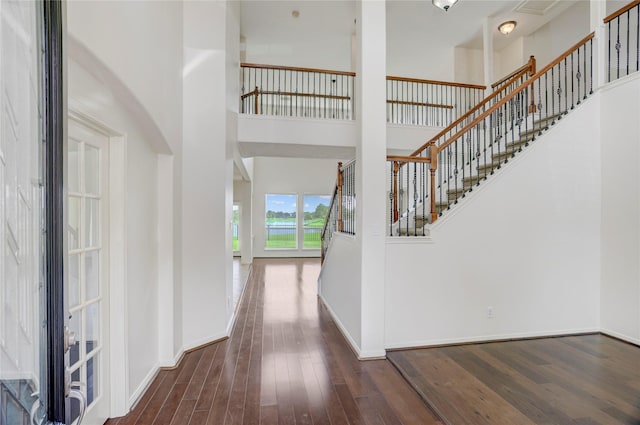 13508 Sweet Wind Ct, Pearland, TX 77584 - foyer featuring wood finished floors, a high ceiling, and stairway