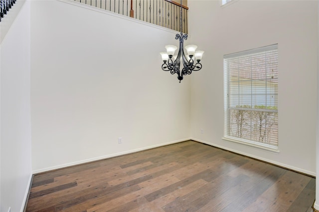 13508 Sweet Wind Ct, Pearland, TX 77584 - unfurnished room featuring a chandelier, dark wood-style flooring, and a high ceiling