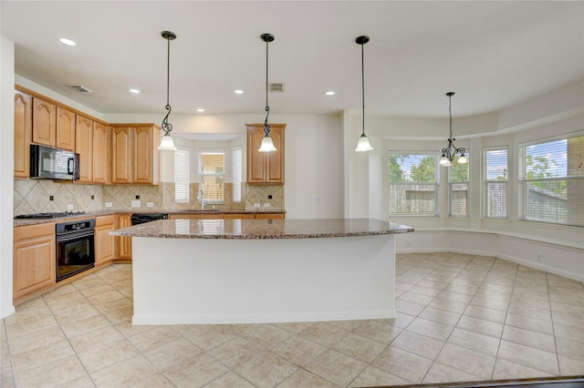 13508 Sweet Wind Ct, Pearland, TX 77584 - kitchen featuring black appliances, plenty of natural light, stone counters, a kitchen island, and recessed lighting