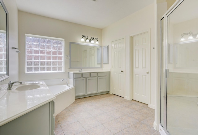13508 Sweet Wind Ct, Pearland, TX 77584 - full bathroom featuring two vanities, a garden tub, a shower stall, and tile patterned flooring