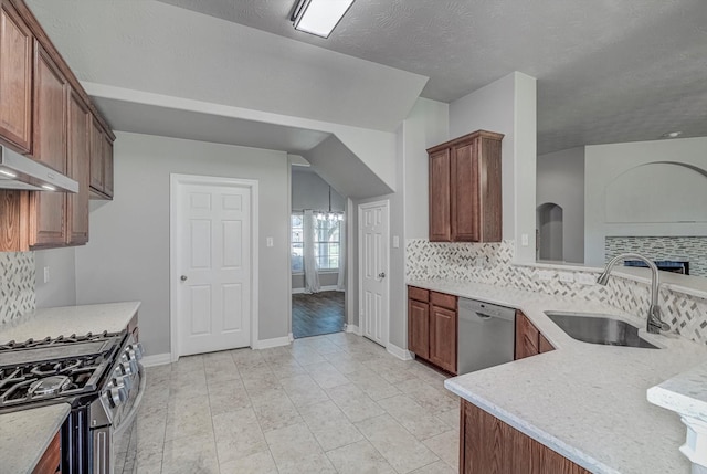 8014 Pine Wood Ct, Baytown, TX 77523 - kitchen with appliances with stainless steel finishes, tasteful backsplash, under cabinet range hood, and light stone countertops