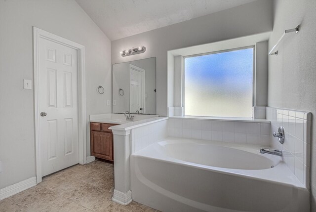 8014 Pine Wood Ct, Baytown, TX 77523 - full bath featuring vanity, a bath, tile patterned flooring, and lofted ceiling