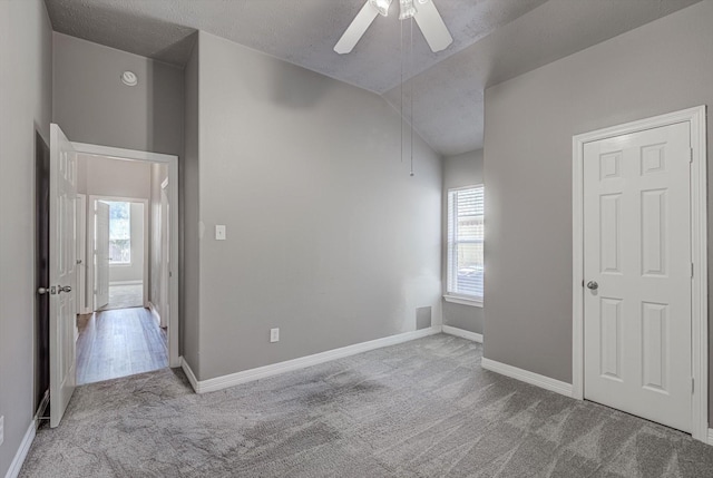 8014 Pine Wood Ct, Baytown, TX 77523 - unfurnished bedroom featuring carpet floors, vaulted ceiling, and a ceiling fan