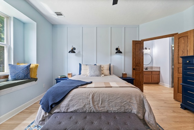 9119 Bush Buck Ln, Conroe, TX 77303 - bedroom with light wood-style flooring and multiple windows