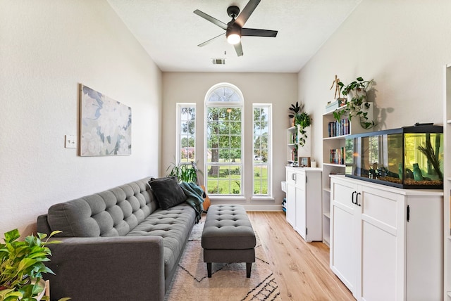 9119 Bush Buck Ln, Conroe, TX 77303 - living area with light wood-type flooring and a ceiling fan