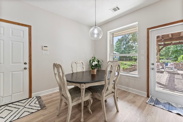 9119 Bush Buck Ln, Conroe, TX 77303 - dining room featuring light wood-style floors and baseboards