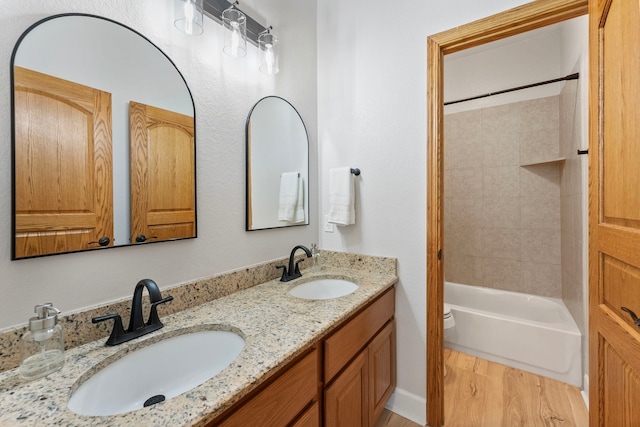 9119 Bush Buck Ln, Conroe, TX 77303 - bathroom with double vanity, shower / bath combination, and wood finished floors