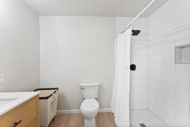 9119 Bush Buck Ln, Conroe, TX 77303 - full bathroom with wood finished floors, a tile shower, and vanity