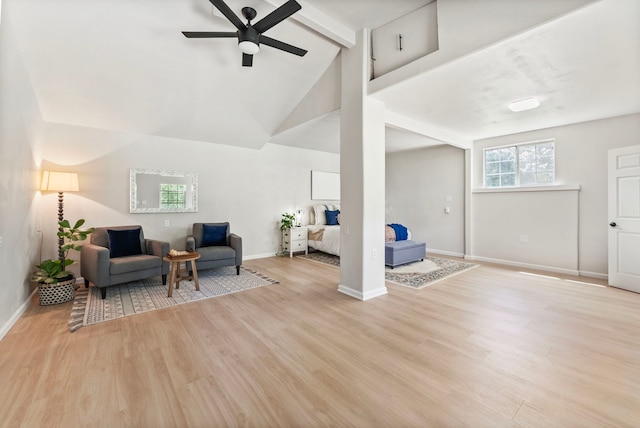 9119 Bush Buck Ln, Conroe, TX 77303 - living area featuring beamed ceiling, a ceiling fan, light wood finished floors, and high vaulted ceiling