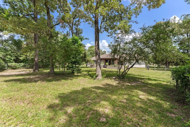 9119 Bush Buck Ln, Conroe, TX 77303 - view of green lawn with a gazebo