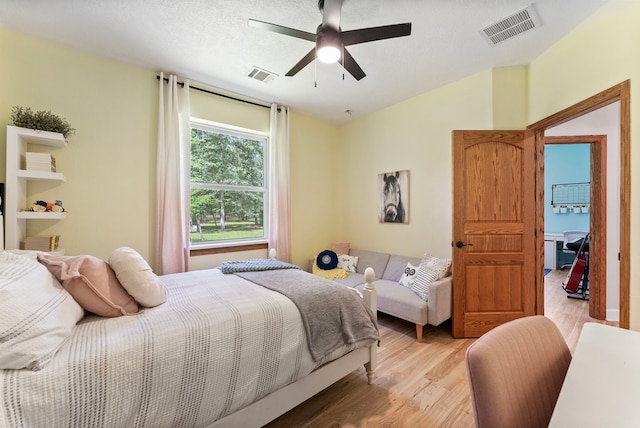 9119 Bush Buck Ln, Conroe, TX 77303 - bedroom with light wood-type flooring and a ceiling fan