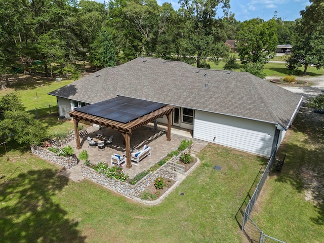 9119 Bush Buck Ln, Conroe, TX 77303 - back of house featuring a patio, roof with shingles, and a fenced backyard