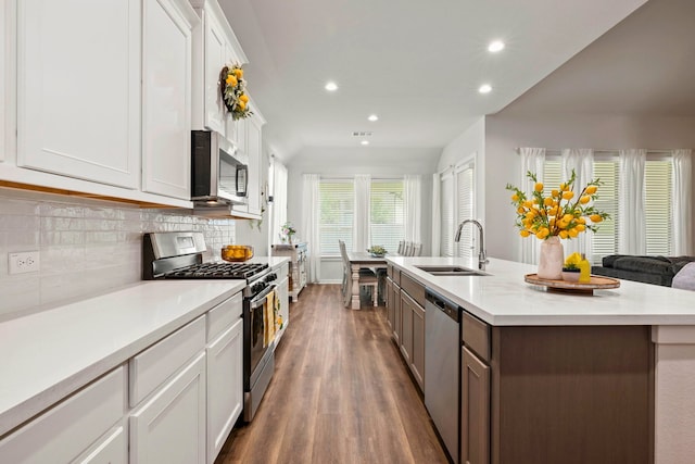 3023 Tantara Dr, Katy, TX 77493 - kitchen with appliances with stainless steel finishes, recessed lighting, dark wood finished floors, light countertops, and tasteful backsplash
