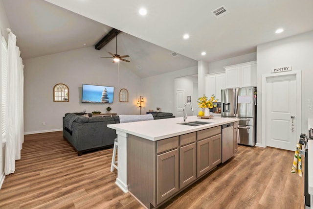 3023 Tantara Dr, Katy, TX 77493 - kitchen with appliances with stainless steel finishes, wood finished floors, light countertops, a center island with sink, and recessed lighting