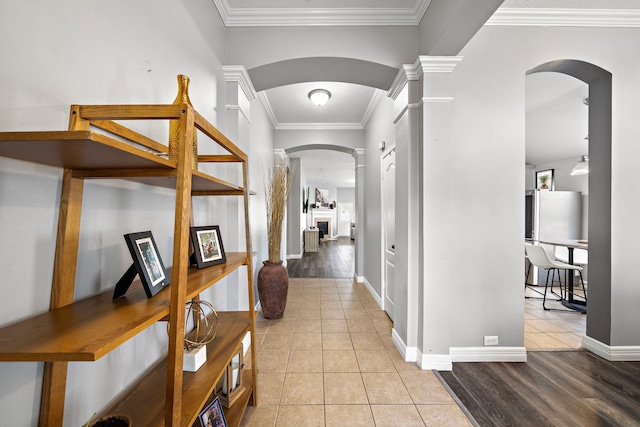 1727 Caldbeck Ln, Fresno, TX 77545 - foyer entrance with arched walkways, ornamental molding, light tile patterned floors, decorative columns, and a fireplace