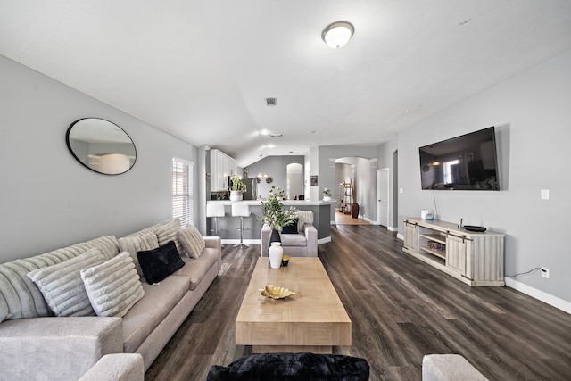 1727 Caldbeck Ln, Fresno, TX 77545 - living area with arched walkways, dark wood-style floors, and lofted ceiling