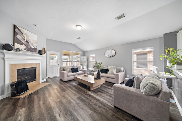 1727 Caldbeck Ln, Fresno, TX 77545 - living area with lofted ceiling, dark wood-style floors, and a tile fireplace