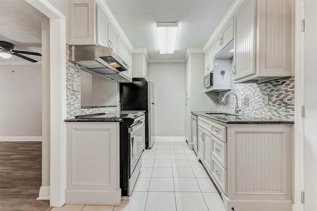 6402 Del Monte Dr Unit 20, Houston, TX 77057 - kitchen with ventilation hood, ceiling fan, decorative backsplash, stainless steel appliances, and ornamental molding