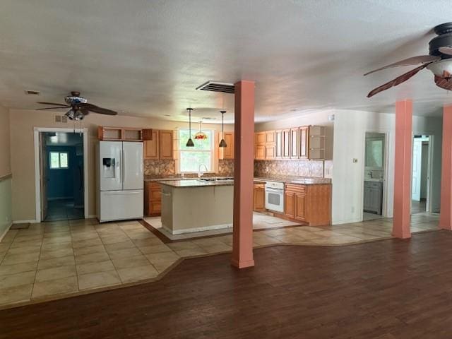 804 Tovrea Rd, Alvin, TX 77511 - kitchen with white appliances, ceiling fan, light wood finished floors, and tasteful backsplash