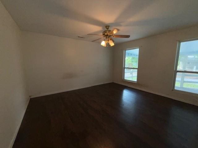 804 Tovrea Rd, Alvin, TX 77511 - spare room with dark wood-type flooring, plenty of natural light, and a ceiling fan