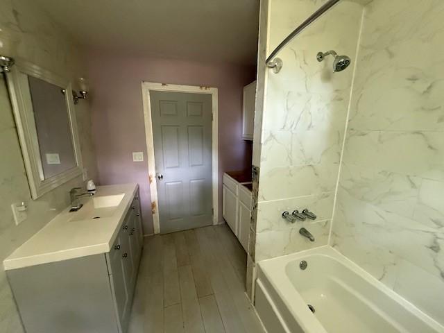 804 Tovrea Rd, Alvin, TX 77511 - bathroom with vanity, wood finished floors, and shower / bathtub combination