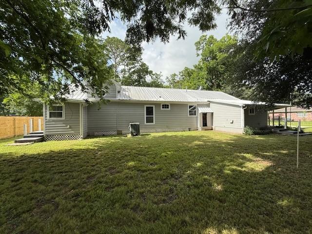 804 Tovrea Rd, Alvin, TX 77511 - rear view of house with a metal roof