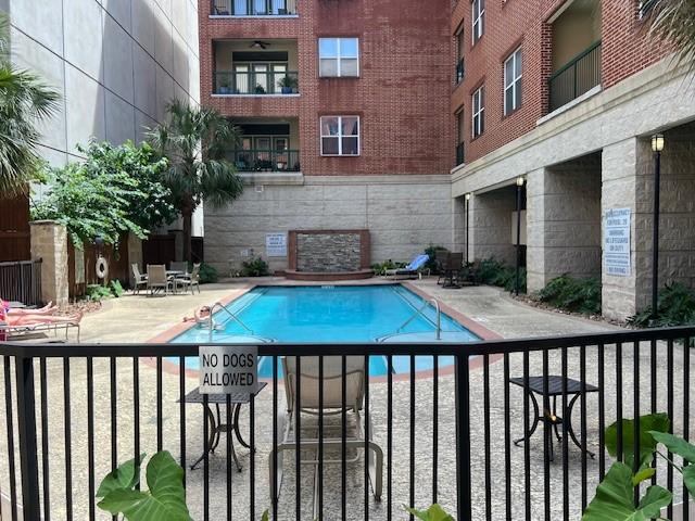 300 St Joseph Pkwy Unit 116, Houston, TX 77002 - community pool featuring a patio area