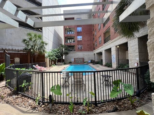 300 St Joseph Pkwy Unit 116, Houston, TX 77002 - community pool with a patio area