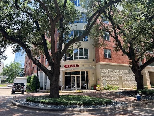 300 St Joseph Pkwy Unit 116, Houston, TX 77002 - view of property with driveway and a garage