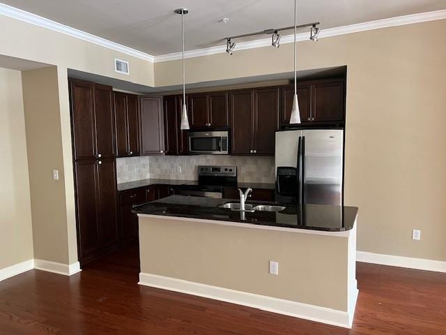 300 St Joseph Pkwy Unit 116, Houston, TX 77002 - kitchen with stainless steel appliances, dark countertops, dark brown cabinetry, tasteful backsplash, and dark wood-type flooring