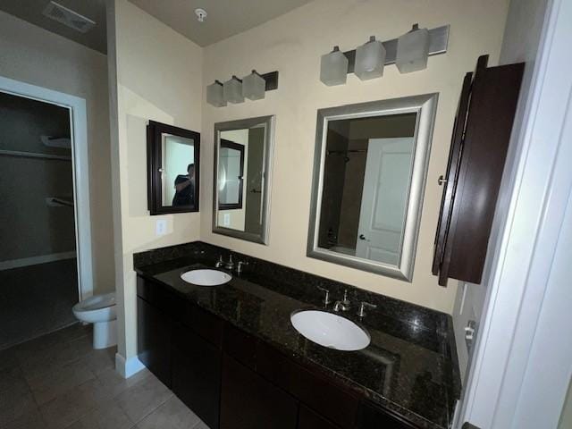 300 St Joseph Pkwy Unit 116, Houston, TX 77002 - full bathroom with double vanity, tile patterned floors, and a spacious closet