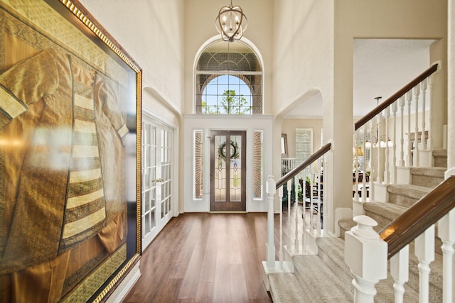 3207 Summerwind Ct, Pearland, TX 77584 - entryway with stairs, a high ceiling, wood finished floors, a chandelier, and arched walkways