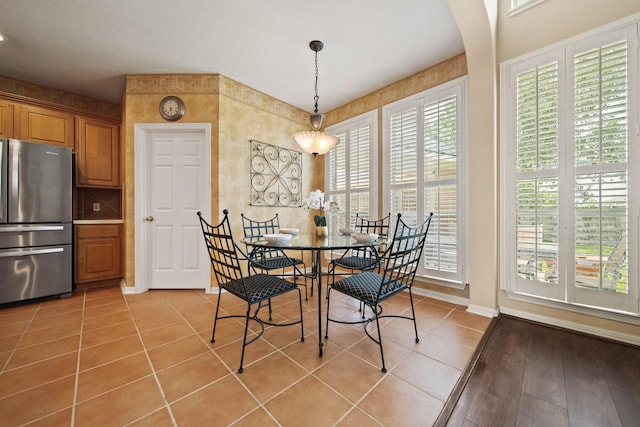 3207 Summerwind Ct, Pearland, TX 77584 - dining area with light tile patterned floors and arched walkways