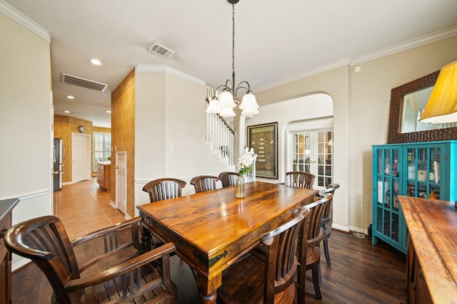 3207 Summerwind Ct, Pearland, TX 77584 - dining space with stairway, arched walkways, crown molding, recessed lighting, and a chandelier