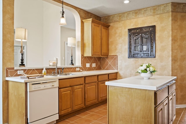 3207 Summerwind Ct, Pearland, TX 77584 - kitchen featuring dishwasher, arched walkways, light tile patterned floors, and light countertops