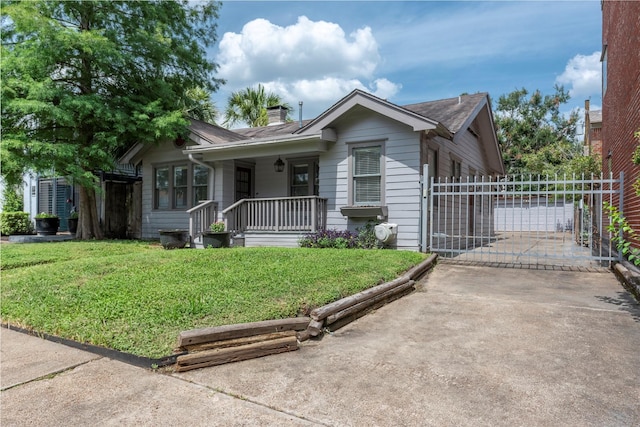 2027 Huldy St, Houston, TX 77019 - view of front of property with driveway, a front lawn, a porch, a chimney, and a gate