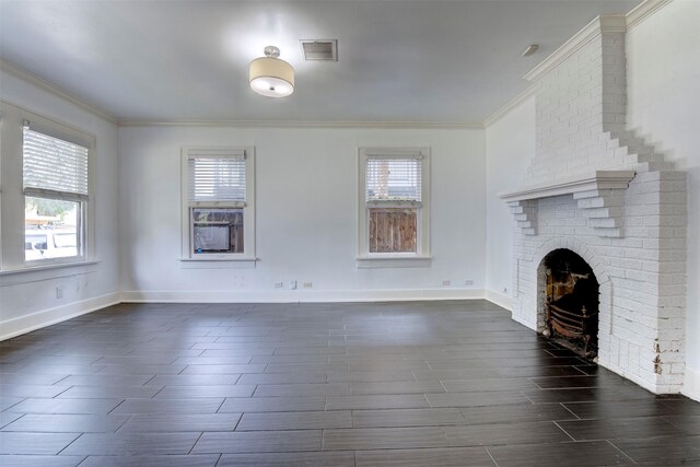 2027 Huldy St, Houston, TX 77019 - unfurnished living room featuring crown molding, healthy amount of natural light, a brick fireplace, and wood tiled floors