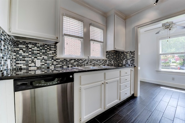 2027 Huldy St, Houston, TX 77019 - kitchen with stainless steel dishwasher, dark countertops, decorative backsplash, and crown molding